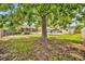 View of the pool and screened patio from the spacious backyard, offering a blend of shade and outdoor living at 335 Oakpark Loop, Davenport, FL 33837