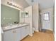 Bathroom featuring double sinks, updated fixtures, and laminate flooring at 335 Oakpark Loop, Davenport, FL 33837