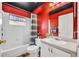 Clean bathroom with white tile and a combination tub and shower at 335 Oakpark Loop, Davenport, FL 33837