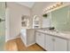 Bathroom features double sinks, updated lighting fixtures, and a bathtub at 335 Oakpark Loop, Davenport, FL 33837