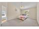 The bedroom features a ceiling fan, neutral walls, and access to a private bathroom with a garden tub at 335 Oakpark Loop, Davenport, FL 33837