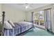 Cozy bedroom featuring a bright window and a comfortable-looking bed at 335 Oakpark Loop, Davenport, FL 33837