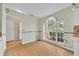 Bright breakfast nook with large window and wood-look laminate flooring at 335 Oakpark Loop, Davenport, FL 33837
