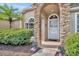 Inviting front entrance with stone archway and manicured landscaping at 335 Oakpark Loop, Davenport, FL 33837