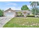 Charming single-story home features a stone-accented facade and a well-maintained lawn at 335 Oakpark Loop, Davenport, FL 33837