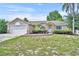 Charming single-story home features a stone-accented facade and a well-maintained lawn at 335 Oakpark Loop, Davenport, FL 33837