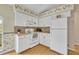 The kitchen features white cabinets, tile backsplash and essential appliances, creating a functional space at 335 Oakpark Loop, Davenport, FL 33837