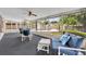 Screened lanai with comfortable seating and a view of the pool and backyard at 335 Oakpark Loop, Davenport, FL 33837