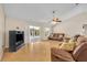 Spacious living room with light hardwood floors, fan, and sliding glass doors at 335 Oakpark Loop, Davenport, FL 33837