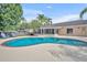Lush backyard with a beautiful pool and plenty of space for lounging and entertaining at 335 Oakpark Loop, Davenport, FL 33837