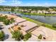 Aerial view of the property with a tile roof and waterfront location at 3533 Somerset Cir, Kissimmee, FL 34746