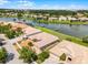 Aerial view of home with private dock, landscaping and tile roof in lake community at 3533 Somerset Cir, Kissimmee, FL 34746