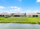 Backyard shot of a home with a well-maintained lawn and water views at 3533 Somerset Cir, Kissimmee, FL 34746