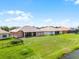 A broad backyard with verdant lawn, situated adjacent to a tranquil pond at 3533 Somerset Cir, Kissimmee, FL 34746