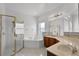 Bright bathroom featuring a glass shower, tub, and vanity with a marble countertop at 3533 Somerset Cir, Kissimmee, FL 34746