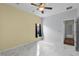 Spacious bedroom featuring marble floors, ceiling fan, and a window at 3533 Somerset Cir, Kissimmee, FL 34746