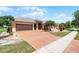 Beautiful single-story house boasting a tile roof, a large driveway, and meticulous landscaping at 3533 Somerset Cir, Kissimmee, FL 34746