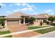 Inviting single-story home with a tiled roof, two-car garage, and an attractive, easy-care yard at 3533 Somerset Cir, Kissimmee, FL 34746