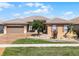 Single-story home featuring a tile roof, a two-car garage, and a decorative, low-maintenance front yard at 3533 Somerset Cir, Kissimmee, FL 34746