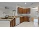 Kitchen featuring granite countertops, wooden cabinets and a breakfast bar at 3533 Somerset Cir, Kissimmee, FL 34746