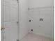 Laundry room with tile floors, door, wire rack shelving, and hookups at 3533 Somerset Cir, Kissimmee, FL 34746