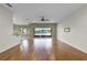 The spacious living room features wood flooring and a lake view at 3533 Somerset Cir, Kissimmee, FL 34746
