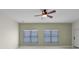 Bright living room featuring modern roller shades on windows and a ceiling fan at 3533 Somerset Cir, Kissimmee, FL 34746