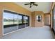 Enclosed patio featuring sliding glass doors with lake views and ceiling fan at 3533 Somerset Cir, Kissimmee, FL 34746