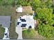 Aerial view of the property showcasing the home's layout, solar panels, spacious backyard, and surrounding greenery at 37 Pecan Pass Trl, Ocala, FL 34472