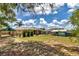 Large backyard showcasing a storage shed, Margaritaville-themed shed, and mature trees; ideal for outdoor living at 37 Pecan Pass Trl, Ocala, FL 34472