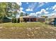 The large backyard features mature trees, a screened-in porch, a fire pit area, and a unique Margaritaville-themed shed at 37 Pecan Pass Trl, Ocala, FL 34472