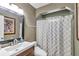 Cozy bathroom featuring a shower with tub, vanity sink, mirror, and neutral design at 37 Pecan Pass Trl, Ocala, FL 34472