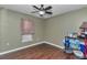 Bedroom features a ceiling fan, neutral walls, and wood-look flooring at 37 Pecan Pass Trl, Ocala, FL 34472