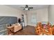 Bedroom with wood-look floors, a ceiling fan, and neutral paint at 37 Pecan Pass Trl, Ocala, FL 34472