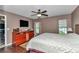 Comfortable bedroom features neutral walls, ceiling fan, and two windows at 37 Pecan Pass Trl, Ocala, FL 34472