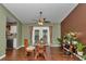 Bright dining room features a glass table, views to the back yard, and stylish decor at 37 Pecan Pass Trl, Ocala, FL 34472
