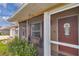 Inviting screened front porch with bench seating and a charming front door at 37 Pecan Pass Trl, Ocala, FL 34472