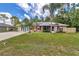 Charming single-story home with mature trees, solar panels, awnings, and a spacious front lawn at 37 Pecan Pass Trl, Ocala, FL 34472
