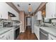 Charming kitchen features granite countertops, stainless appliances, and bright white cabinetry at 37 Pecan Pass Trl, Ocala, FL 34472