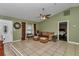 Comfortable living room featuring tile floors, a ceiling fan, and neutral décor at 37 Pecan Pass Trl, Ocala, FL 34472