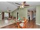 Open-concept living area features tile and hardwood flooring, multiple ceiling fans and dining space at 37 Pecan Pass Trl, Ocala, FL 34472