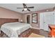 Main bedroom featuring wood-look floors, a ceiling fan, and an ensuite bathroom at 37 Pecan Pass Trl, Ocala, FL 34472