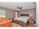 Cozy main bedroom features a ceiling fan, wood-look floors, and ample natural light at 37 Pecan Pass Trl, Ocala, FL 34472
