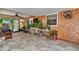 Bright sunroom featuring wood-look tile, ceiling fan, and view of backyard at 37 Pecan Pass Trl, Ocala, FL 34472