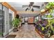 Bright sunroom featuring wood-look tile, ceiling fan, and view of backyard at 37 Pecan Pass Trl, Ocala, FL 34472