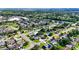 An expansive aerial view of a community with lush green spaces and a nearby lake at 4026 Seabridge Dr, Orlando, FL 32839
