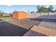 Fenced backyard showcasing a storage shed on a well-maintained and landscaped lot at 4026 Seabridge Dr, Orlando, FL 32839