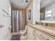 Bathroom featuring granite counters, tile shower with glass door and tile floors at 4026 Seabridge Dr, Orlando, FL 32839