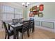 Inviting dining room featuring a modern table setting, decorative wall art, and ample natural light at 4026 Seabridge Dr, Orlando, FL 32839