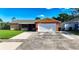 Charming single-story home featuring a two-car garage, a well-manicured lawn, and a classic front facade at 4026 Seabridge Dr, Orlando, FL 32839